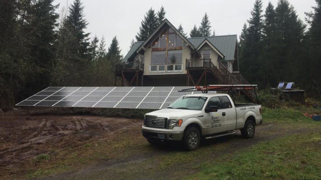 ground mount solar panel with energy solutions of oregon truck in front