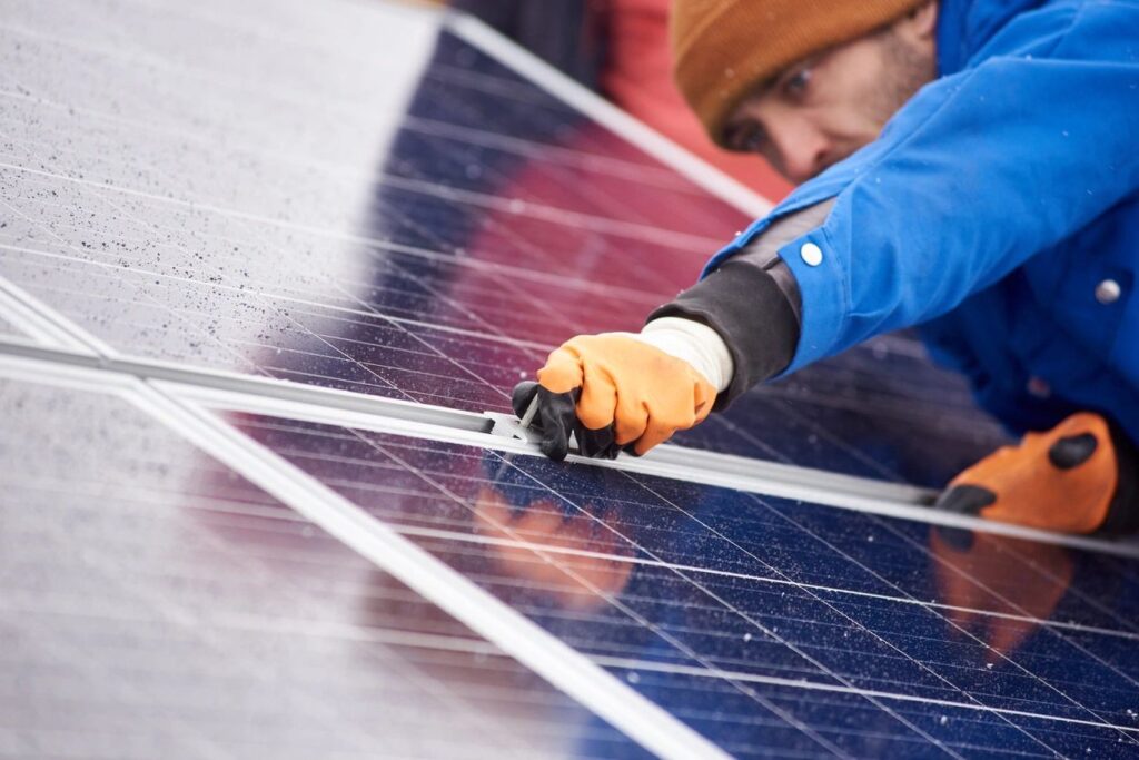 man removing solar panels from the roof